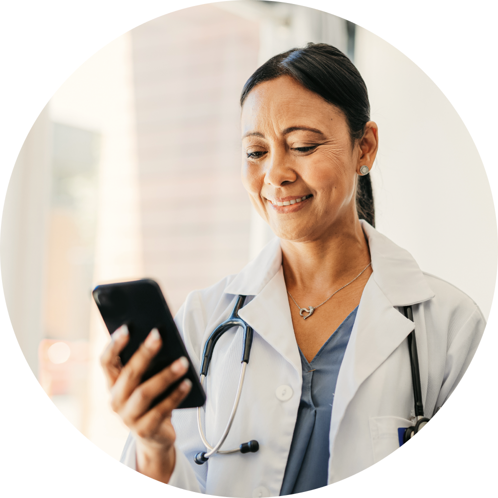 A healthcare provider using the MyCompHealth app on her phone